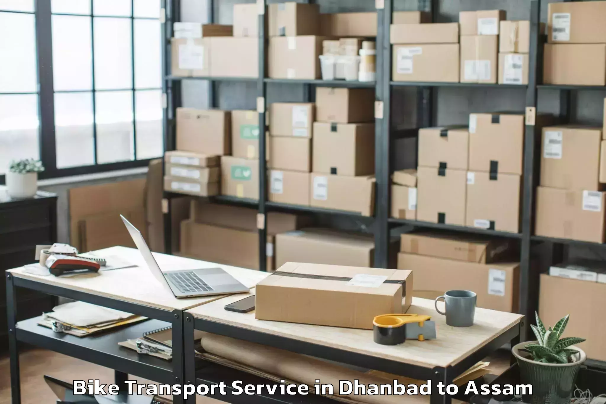 Leading Dhanbad to Kalaigaon Bike Transport Provider